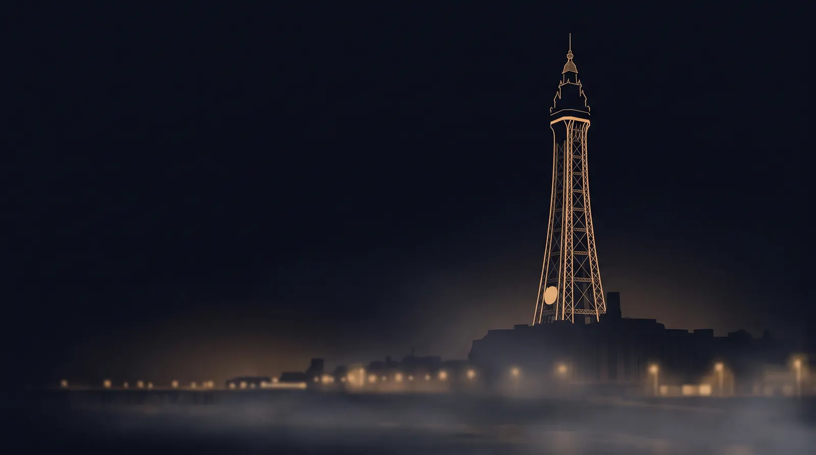Blackpool Tower at night outlined in warm gold light above the promenade
